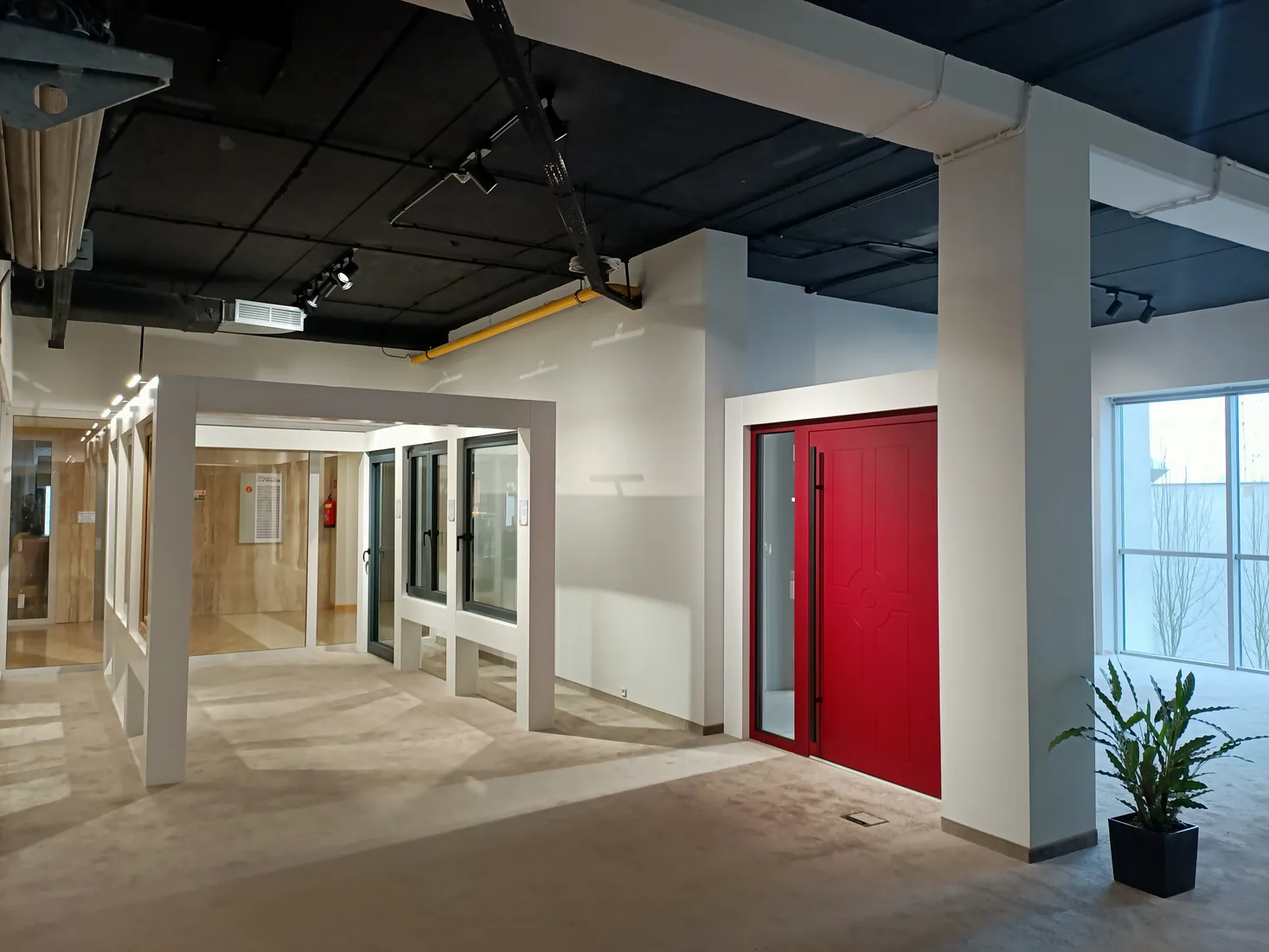 A red entrance door and the row of windows — Salon BUDVAR Poznań – Galeria Arkada